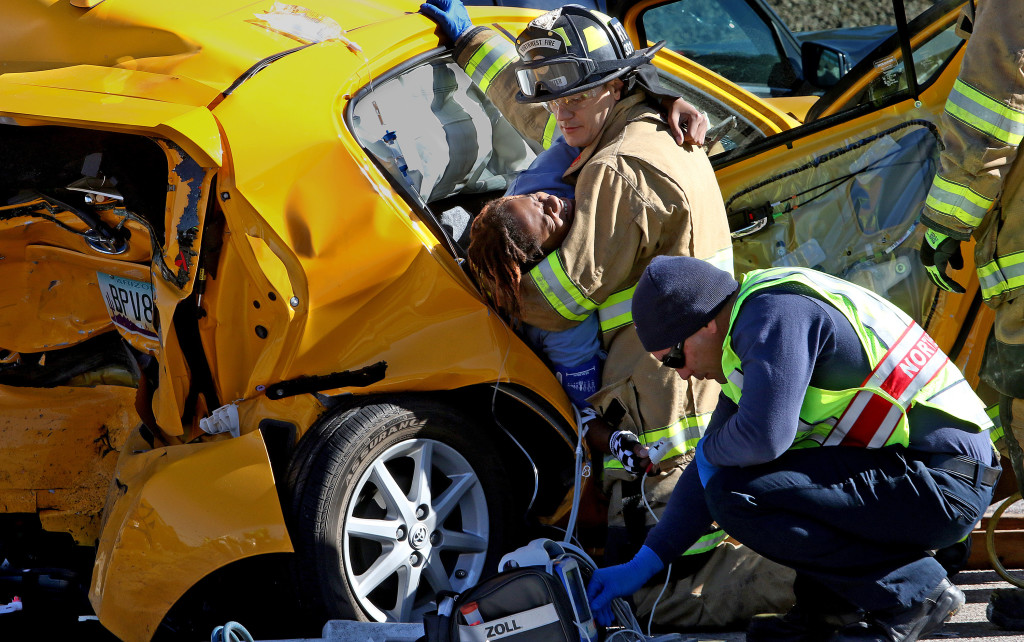 A young man trapped in a crushed Toyota Prius grimaces as members of the Northwest Fire District work to extricate him from the crushed vehicle on the eastbound off ramp at Interstate 10 and Ruthrauff. Several people were injured and transported to local hospitals as four vehicles were involved in the accident at the light. in Tucson, Ariz., on Wednesday, Dec. 30, 2015. A.E. Araiza / Arizona Daily Star