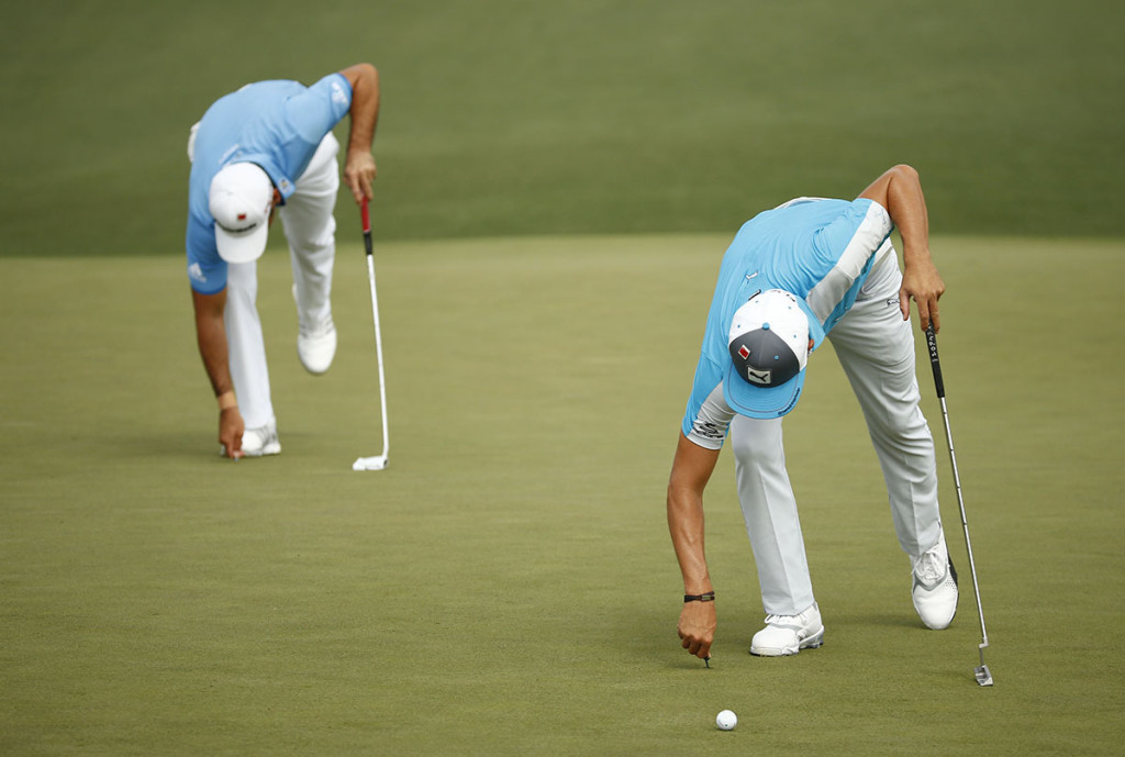 Apr 10, 2015; Augusta, GA, USA; Rickie Fowler (right) and Jason Day (left) repair their ball marks on the 2nd green during the second round of The Masters golf tournament at Augusta National Golf Club. Mandatory Credit: Rob Schumacher-USA TODAY Sports