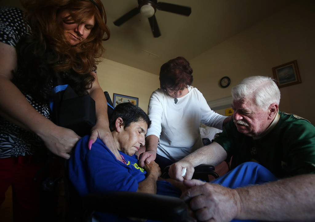 Toby Van Skike, far right, leads a prayer with Jenny Beals, far left, and Sue Pennington, second from right, for Fran Cappadocia, at the end of his visit with Cappadocia at the Arizona State Veteran Home on Wednesday May 06, 2015. Van Skike was wounded on April 26, 1968 while serving in the Vietnam War, Cappadocia was his nurse. After returning to the United States, Van Skike never forgot the nurse who cared for him. Four months ago, Van Skike found Cappadocia and visited her for the first time. Van Skike lives in Benson, but drives to Tucson to visit Cappadocia every couple of weeks. Cappadocia has been diagnosed with Alzheimer's and severe post traumatic stress disorder. Mamta Popat / Arizona Daily Star