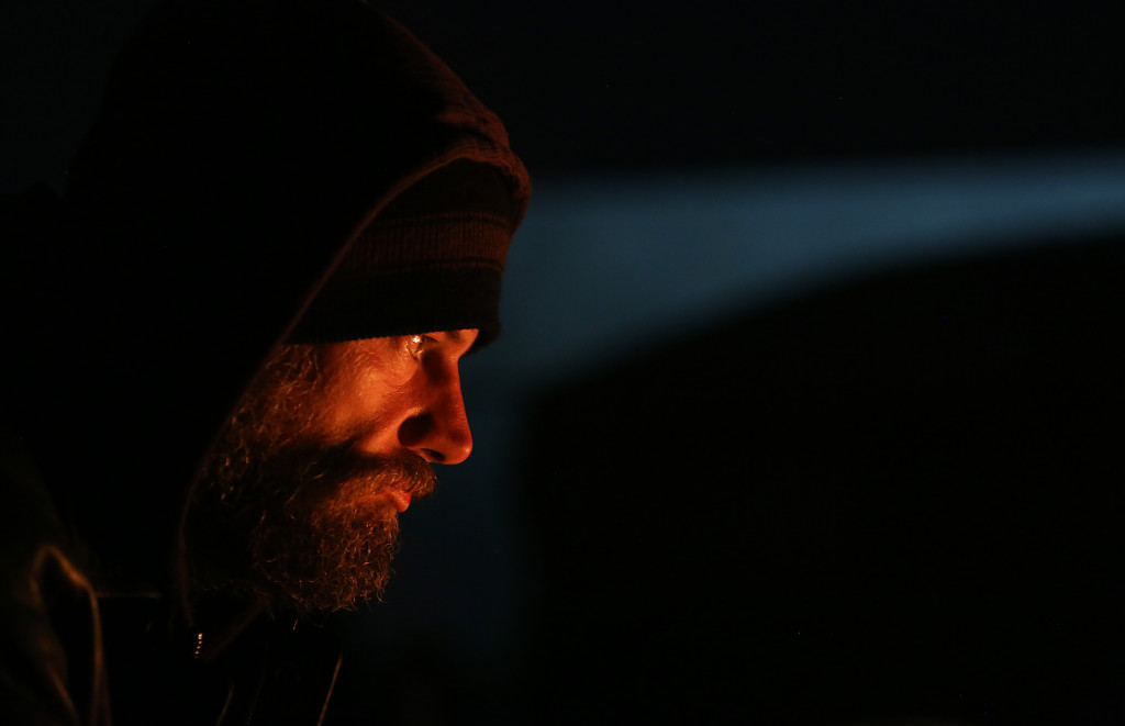 Jeff Kelly sits by the fire to warm up on Thursday November 19, 2015 at Camp Bravo in Tucson, Ariz. Kelly says he's been living at the camp for a week. Veterans on Patrol runs the camp. It was created by a group of veterans to help homeless people, particularly homeless veterans and women and children. The group has set up army tents on private property and has many items like food, clothing and water donated to them. Mamta Popat / Arizona Daily Star