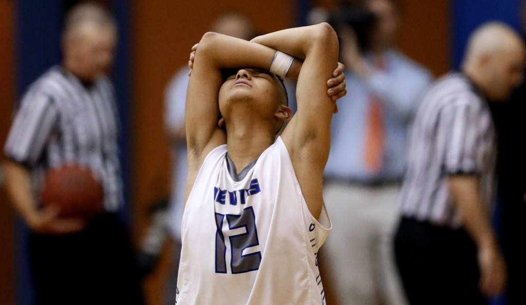 Sunnyside's Mikey Silva (12) reacts after the Blue Devils fouled Nogales' Isaac Ayala (25) in the final seconds with the game tied in the fourth quarter of their Division II, Section II tournament game at Cholla High School, Wednesday, February 11, 2015, Tucson, Ariz. Ayala drained both free throws and Nogales won 49-47. Kelly Presnell / Arizona Daily Star