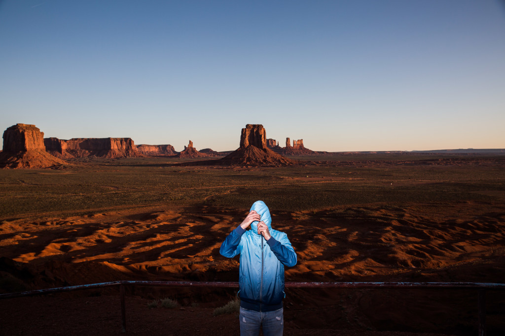 4/9/2015 - Vlad Odobescu prepares to unzip his hoodie after posing for a portrait in the extreme morning cold of Monument Valley Thursday morning in Northern Ariz.. Photo by Deanna Dent/Cronkite Journal